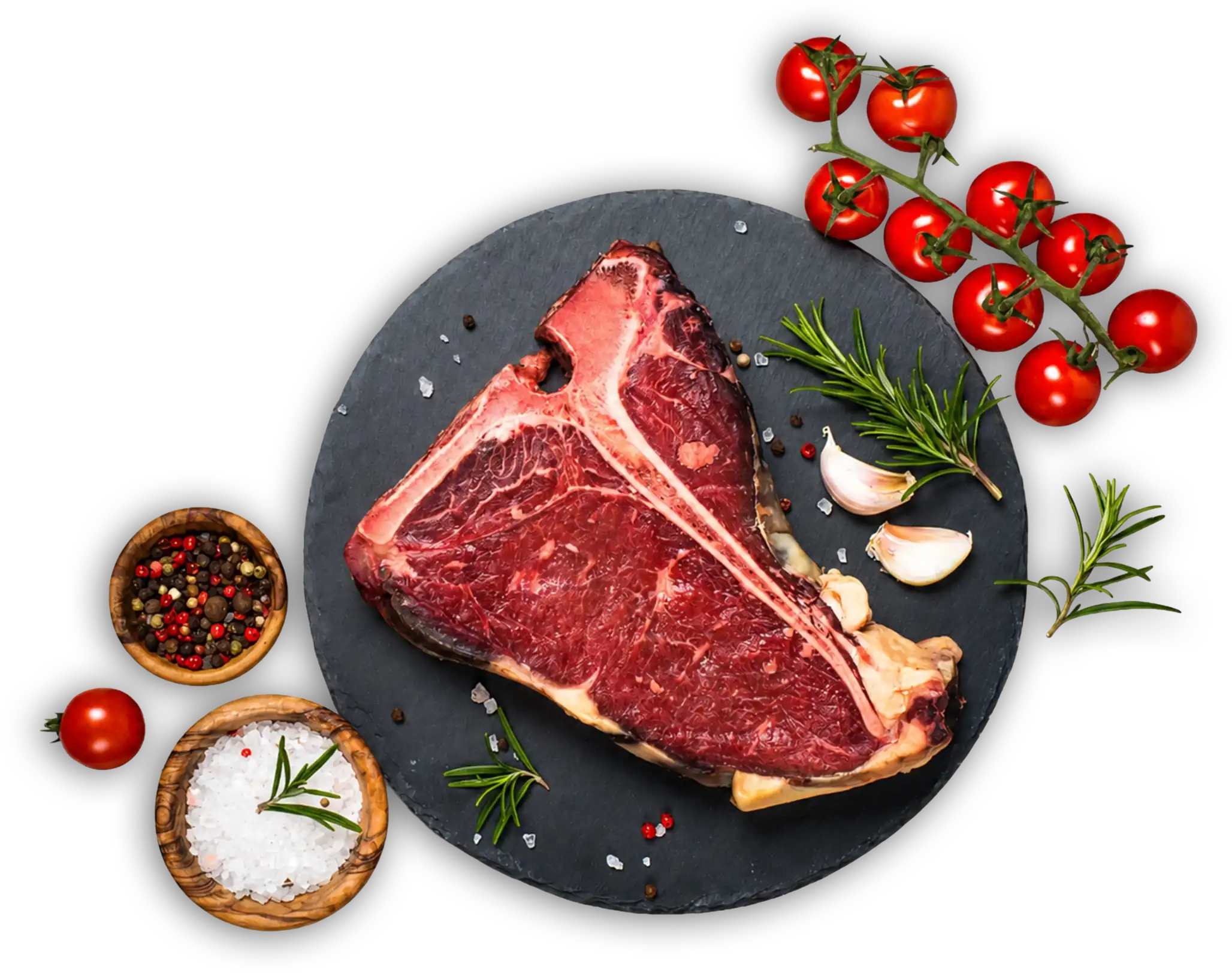 Corte de T-Bone sobre piedra con tomates cherry, ajo y romero
