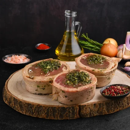 Filet mignon envuelto en tocino con chimichurri sobre tabla de madera rústica